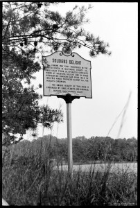The marker in 1973, on the opposite side of the road, and after repairs.