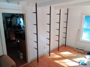 I painted the wall before the shelves went up. A spring at the top of each pole holds it tightly in place.
